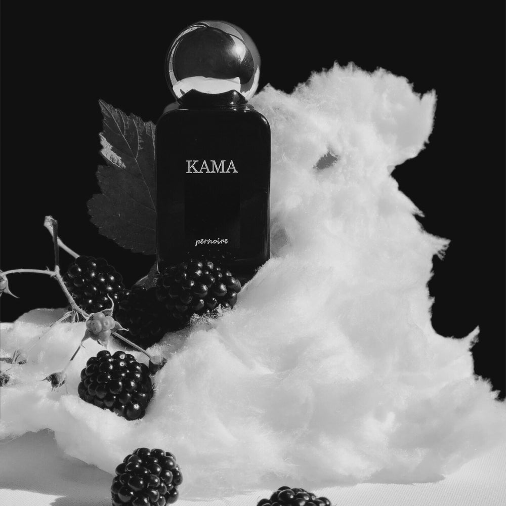 Original KAMA bottle surrounded by blackberries, blackberry leaves and cotton candy.